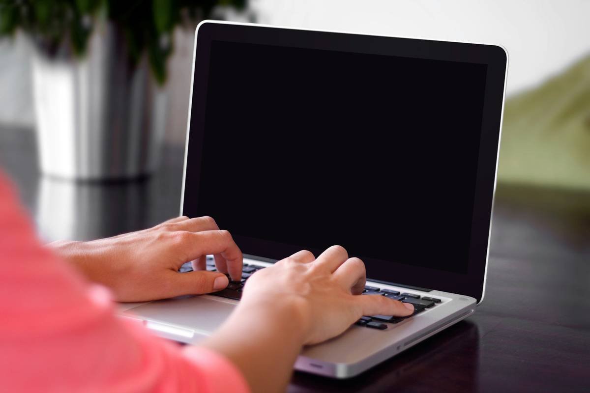 Typing on a laptop